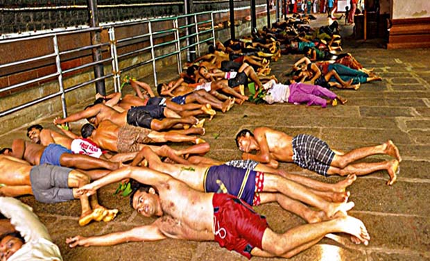 devotees rolling over the plantain leaves, once food has been partaken by Brahmins